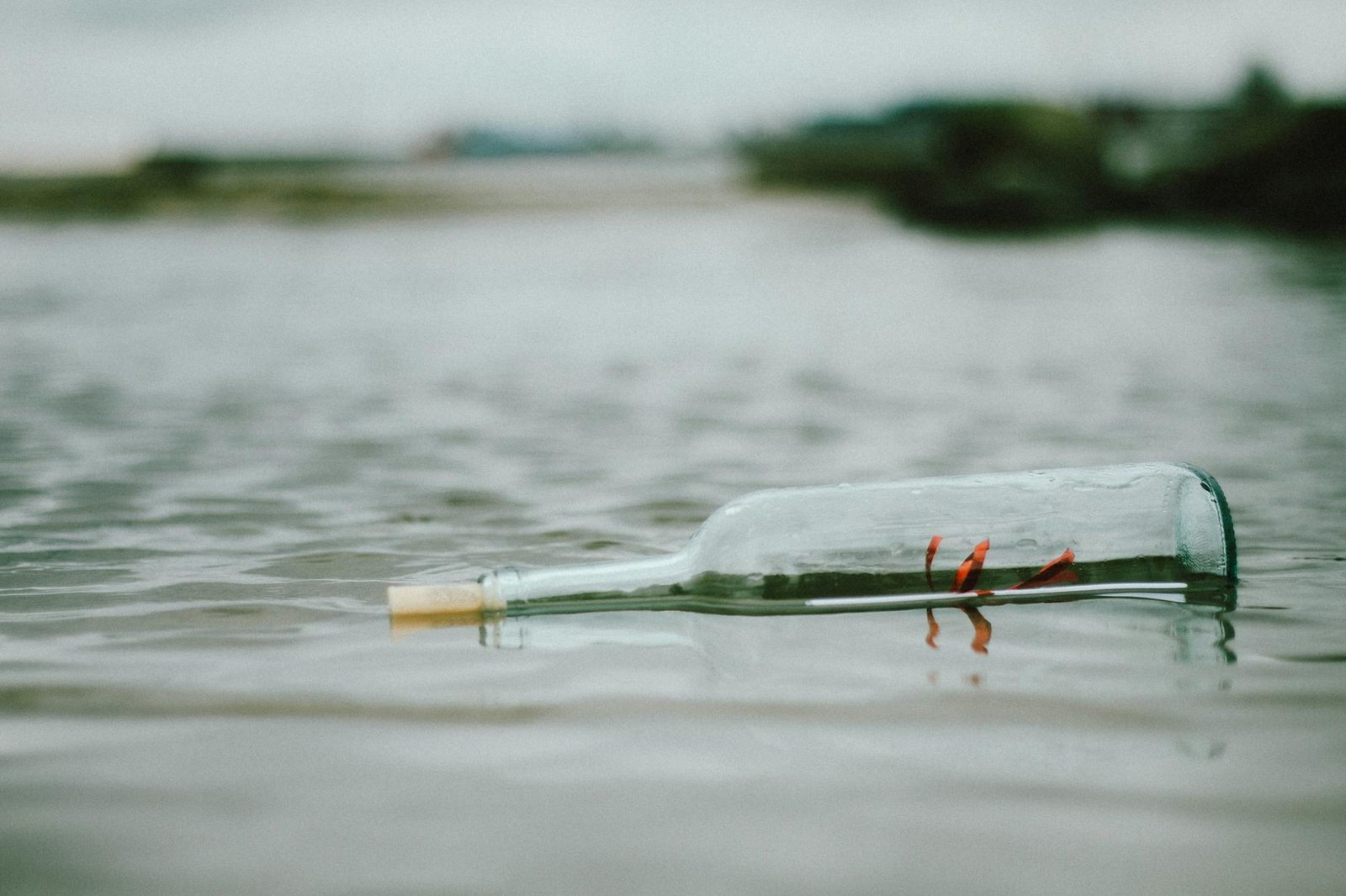 selective focus photo of bottle floating on body of water