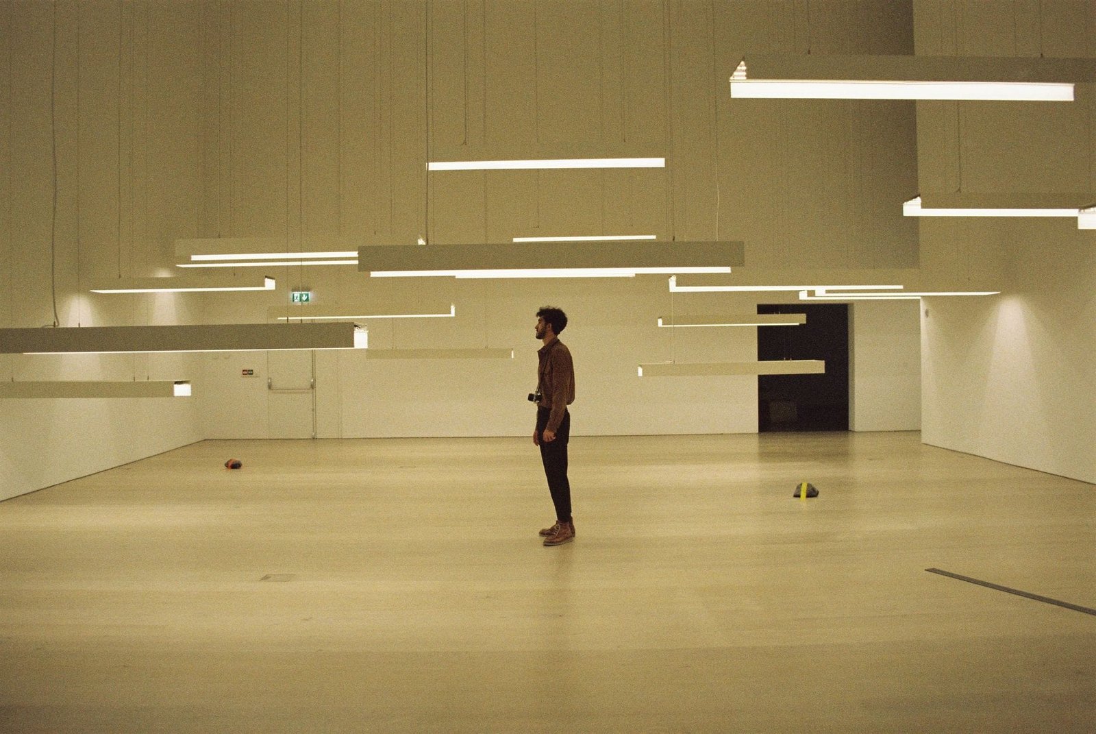 a man standing in a room with hanging lights